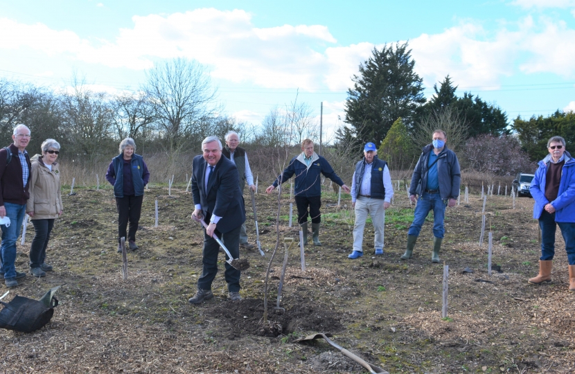 Sir Oliver putting the finishing touches to the planting with Baldock Rotary members.